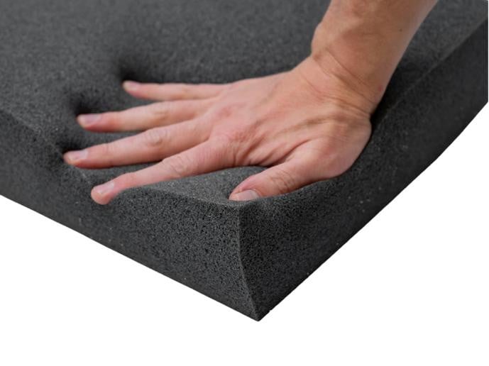 Memory Foam Upholstery Sheet, close-up of a hand pressing into the soft, dense black foam to demonstrate its cushioning and supportive properties.