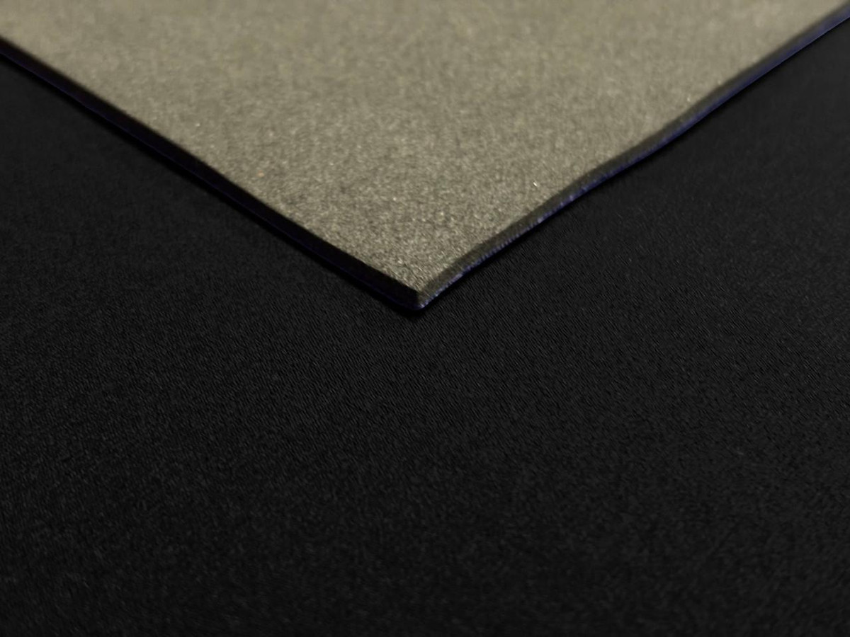 1.5mm Neoprene Sheet, product image showing a close-up of the front plain rubber surface and the black nylon back side.