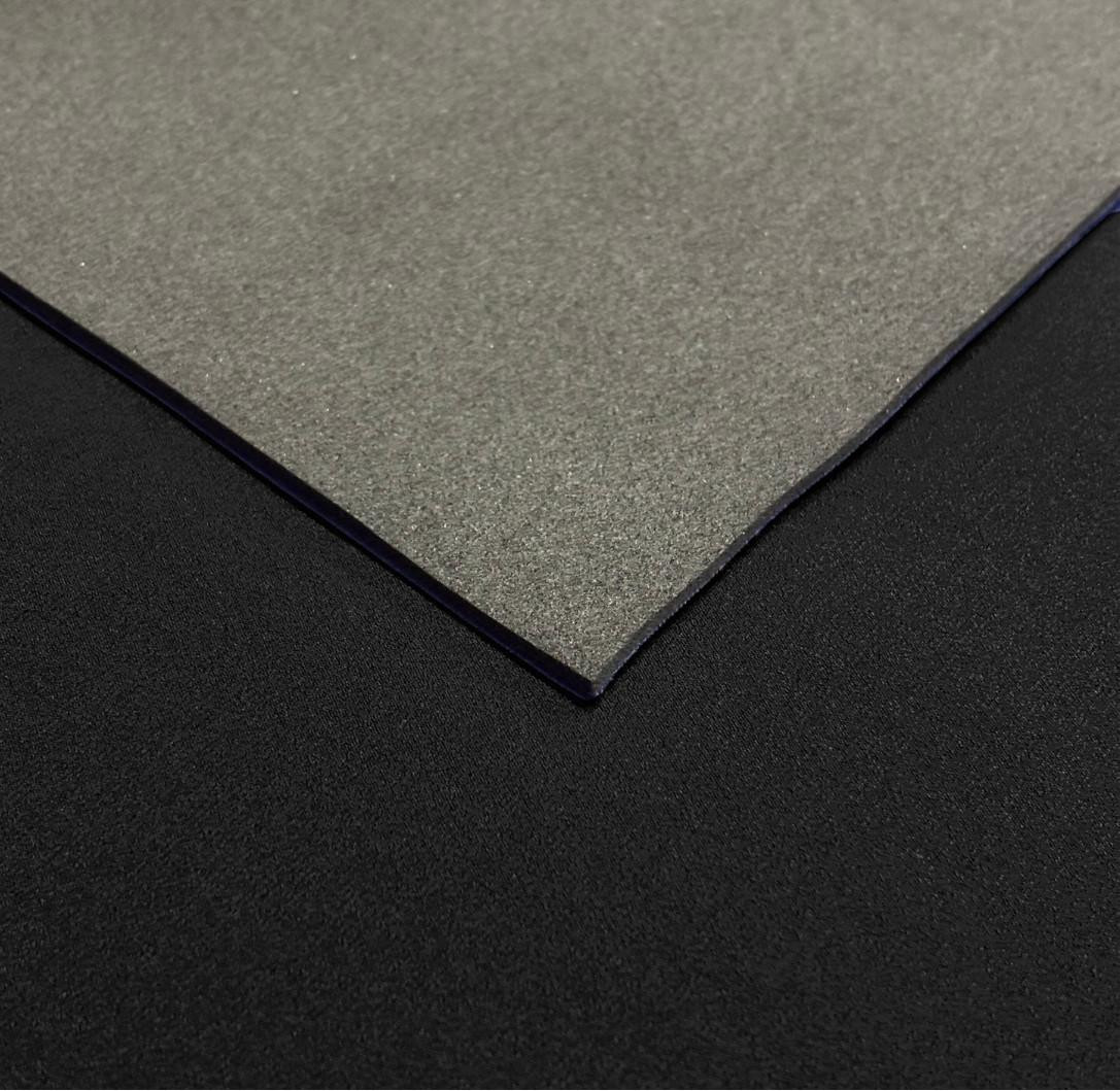 1.5mm Neoprene Sheet, front: plain rubber surface, back: black nylon layer, close-up view showing texture and edges.