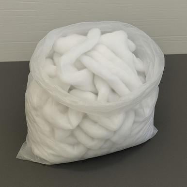 Scrap polyester batting, a large clear plastic bag filled with tangled white polyester fibers used for quilting and upholstery.