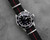 Black and red nylon watch strap on a Rolex Submariner