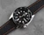 Black racing watch band with orange stitching