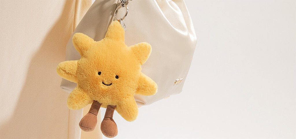 Sun charm hangs from bag.