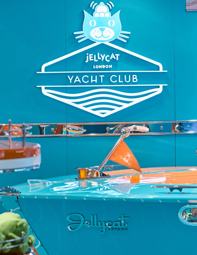 Jellycat Yacht Club sign above a turquoise boat-themed display with an orange flag.