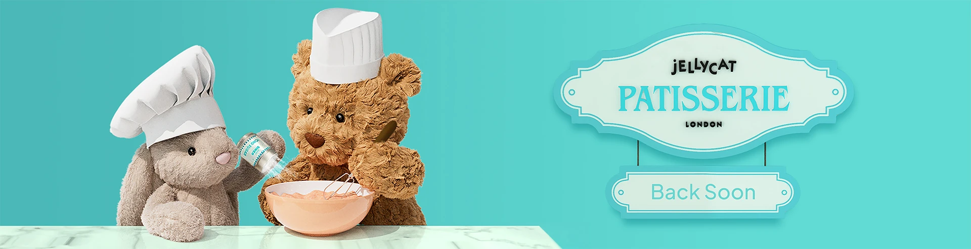 Bartholomew Bear and Bashful Beige Bunny baking together beneath a Jellycat Patisserie London "Back Soon" sign.
