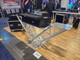 ProX V-shape DJ table showcased with professional controller setup for mobile DJs, event production, and live performance applications