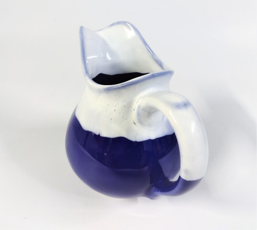 medium size jug glazed in cobalt blue with white top 