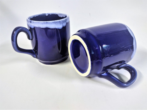 Two small coffee mugs glazed in cobalt blue with white rim 