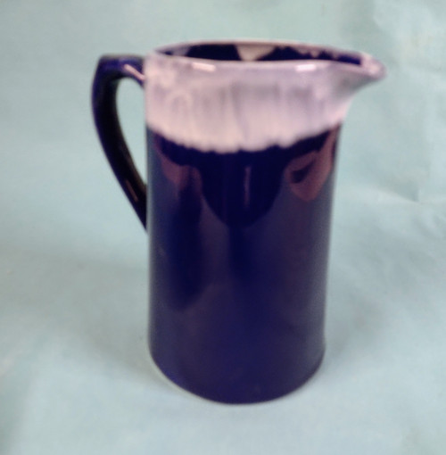 Craft made pottery cobalt blue jug with whit rim