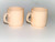 2 small mugs glazed in cream 