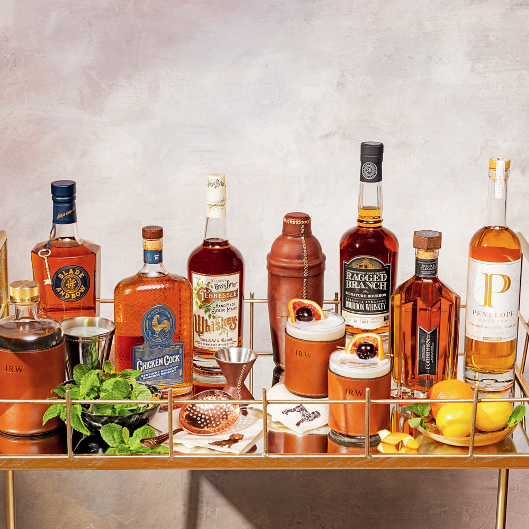Bar cart with bottles, barware and cocktail napkins