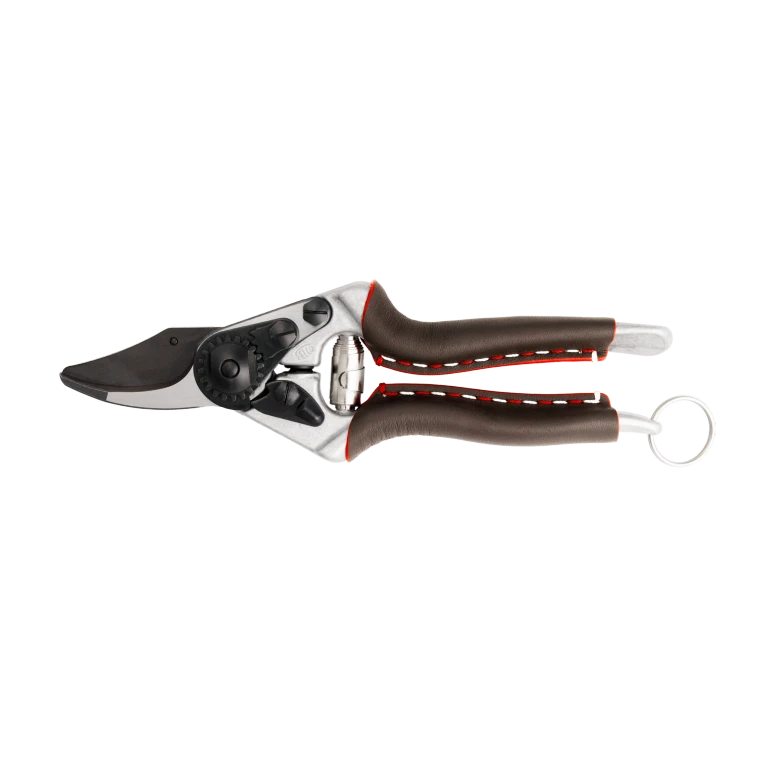 The FELCO 6 Elite Premium Pruning Shears represent the finest evolution of the iconic FELCO 6. Designed for professionals and discerning gardeners, they combine luxury genuine leather grips, an advanced F-Tech coated blade, and lightweight forged aluminium handles to deliver exceptional cutting performance, comfort and durability. Purpose-built for medium-sized right hands, the FELCO 6 Elite offers clean, precise cuts up to 20mm while showcasing Swiss craftsmanship in every detail.