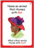 Educational card game, with a woman wearing a colorful hat featuring purple feathers and flowers, asking to name an animal that rhymes with 'hat' and providing the answer 'cat'.