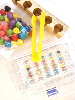 Board Game, lollipop sticks, and colorful gumballs for a fun game activity.