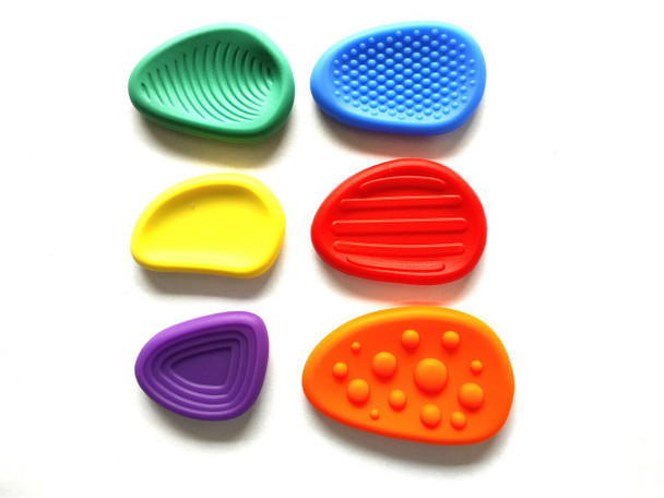 Variety of colorful silicone shoe heel grips, including blue, green, yellow, red, purple, and orange, with different textured surfaces for added grip and comfort.