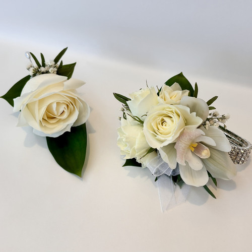 Matching wrist corsage and buttonhole.