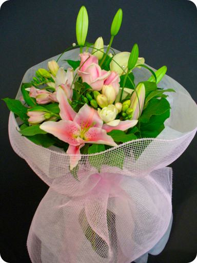 Bouquet of pretty pink and white flowers beautifully arranged with pink and white wrapping and organza bow.