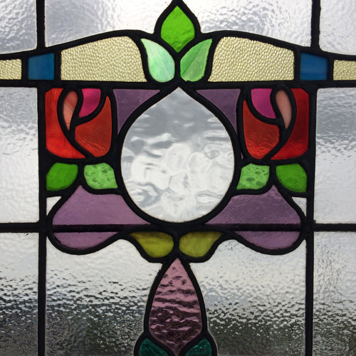Beautifully colourful leaded glass window in a Glasgow Style, with stylised red roses
