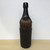 Original vintage brown glass ribbed bottle with GLASGOW insignia on neck.