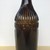 Original vintage brown glass ribbed bottle with GLASGOW insignia on neck.