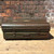 A dark olive green vintage metal trunk