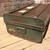 A dark olive green vintage metal trunk