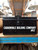A large black vintage metal box with side carrying handles.  Lettering on the front in white : Carronvale Bulding Company No2.   A large black vintage metal box with side carrying handles.  Lettering on the front in white : Carronvale Bulding Company No2.