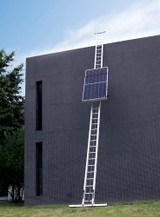 Full load of solar panels lifting to the top of a multi-story roof