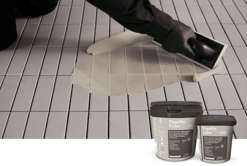 A tiler installing floor tiles using Kerakoll Fugalite Color Waterproof Resin Epoxy Grout