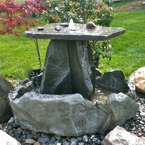 The Athena Garden CF Rock Fountain is a hand-sculpted large 4-piece outdoor water fountain made of cast stone concrete. This water fountain features a unique natural stone design for your landscape or patio setting. 
large stone fountain, garden fountain, sculpted fountain, falling water, garden fountain, concrete fountain, patio water feature, patio fountain, large fountain