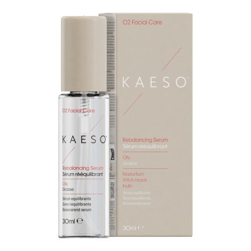 Kaeso KAESO O2 Rebalancing Serum With Added Tri Complex, 30ml - a clear glass bottle with a beige pump dispenser next to its beige and white packaging box, designed for oily skin and containing witch hazel and inulin.