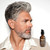 Reuzel Clean & Fresh Beard Serum 50g, a brown glass bottle with a black pump dispenser and label, positioned next to a mature man with a well-groomed gray beard and stylish hair, against a white background.