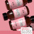 Osmo Ikon Glossy Gloss Toner 60ml, image of multiple pink bottles of Glossy Gloss Toner with black caps displayed on a pink background.