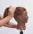 Pivot Point Bridgette Marie Cap - 100% Human Hair Snap Cap, demonstrating a medium-sized hair cap fitted on a mannequin head with reddish-brown hair for styling practice or display.