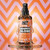 Crazy Color Graffiti Gloss Glossing Spray - 100 ml, spray bottle with graffiti-inspired design, glossy liquid dripping from the bottle, vibrant pink and orange background with geometric pattern