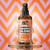 Crazy Color Graffiti Gloss Glossing Spray - 100 ml, spray bottle with graffiti-inspired design, glossy liquid dripping from the bottle, vibrant pink and orange background with geometric pattern