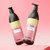 Osmo Ikon Bleach Seeker Indicator Shampoo, two bottles of light purple and black color shampoo for hair bleaching, displayed on a pink background.