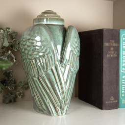 Angel Wings Ceramic Urn Serene on a Bookshelf