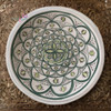 Close-up of the traditional hand-painted geometric and floral designs on a 30cm Moroccan dining plate.
