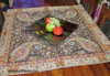 A Persian Termeh cloth displayed as a decorative wall hanging in a sophisticated home office