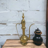 Close-up of the intricately engraved high finial and tiered lid on the 80 cm decorative brass Arabic coffee pot.