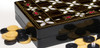 Close-up of the vibrant geometric mosaic print and backgammon points on the 38 cm MDF travel board.