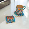 Close-up of the square ceramic coaster highlighting the detailed and vibrant owl artwork set against a deep blue background.