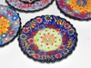 Close-up of assorted 12cm Turkish ceramic plates displaying intricate, colorful traditional designs.