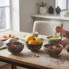 A sophisticated, handcrafted enamel-painted clay bowl that blends cultural artistry with functional, everyday decor utility.
