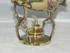 A professional lifestyle presentation shot of the ornate brass teapot and warmer setup showcasing its classic vintage design for tabletop display or serving.