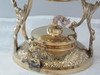 The complete brass teapot and warming stand assembly, emphasizing its classic design and practical tea-warming feature.
