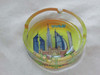 A top-down view of the 12 cm glass ashtray showing the vibrant colors of the Dubai landmarks protected under the glass.