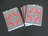 Four assorted Arabic carpet coasters arranged in a fan shape to show the variety of traditional woven designs.