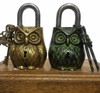 Two 12 cm handmade brass owl locks, one in a polished gold finish and one in an antique green patina finish.